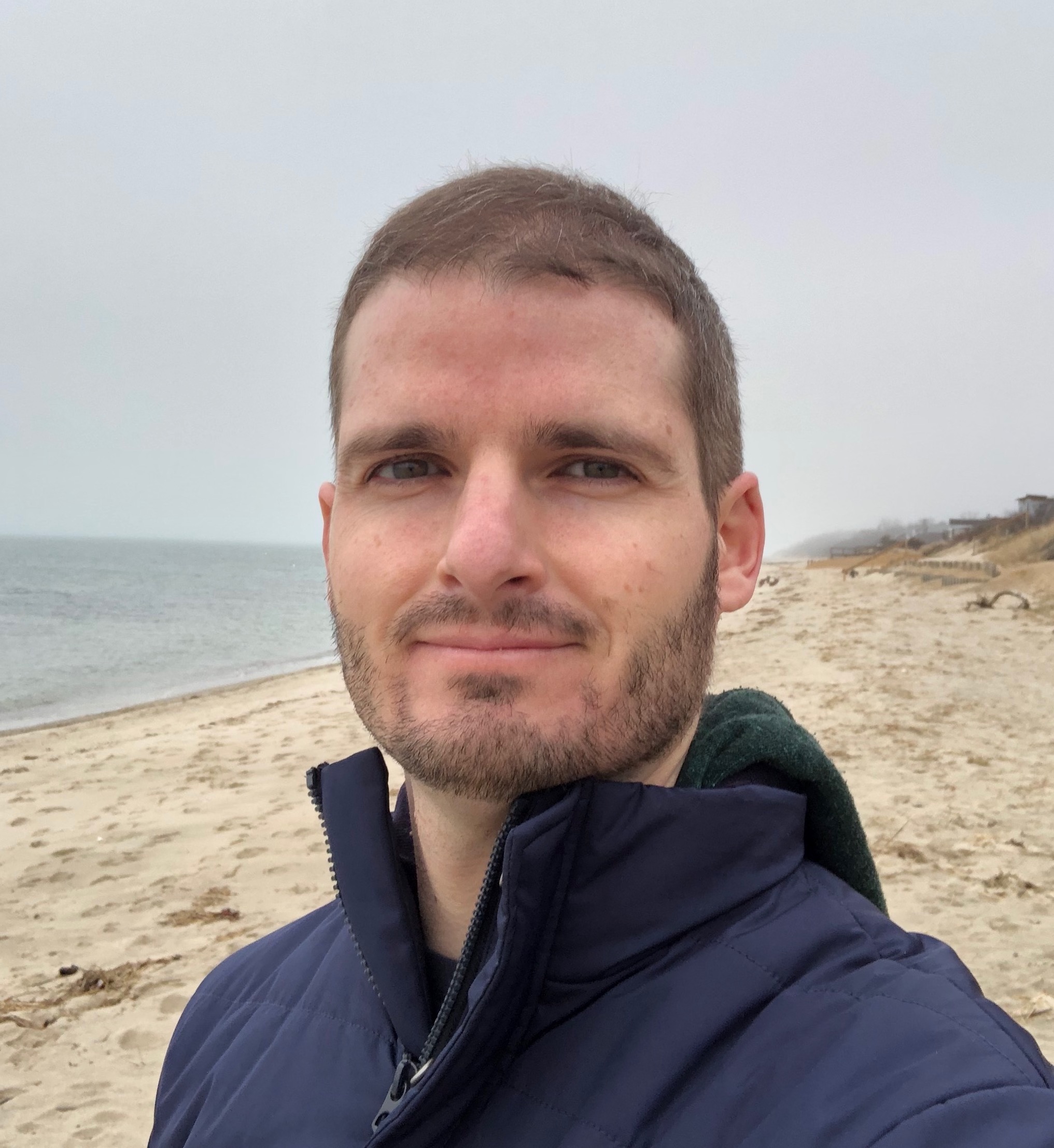 Headshot of man standing on beach